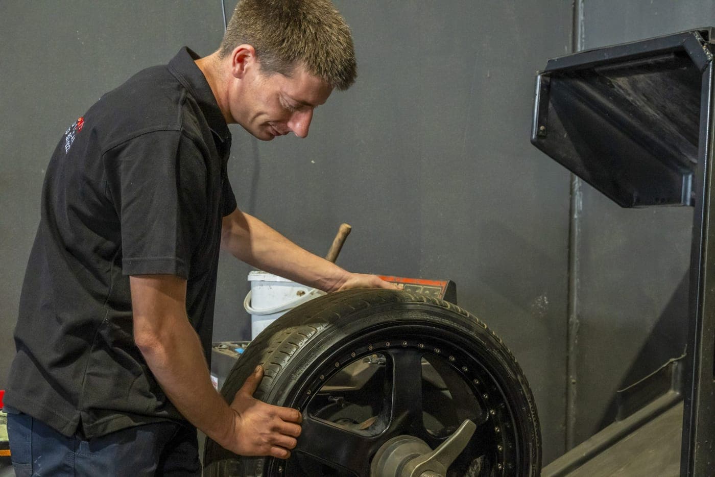 Tyre being fitted and balanced on a wheel in the workshop